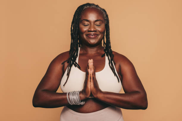 istock Mature woman meditating in a studio 1434685264
