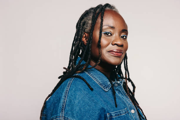 istock Stylish woman with dreadlocks looking at the camera in a studio 1434685693