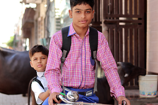 Two school student going to school on cycle.