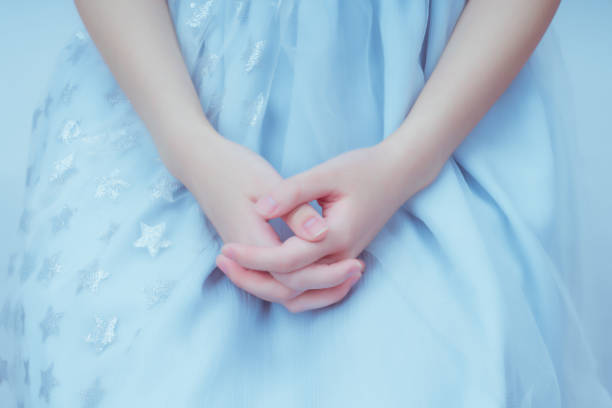 Girl's hands against a blue background