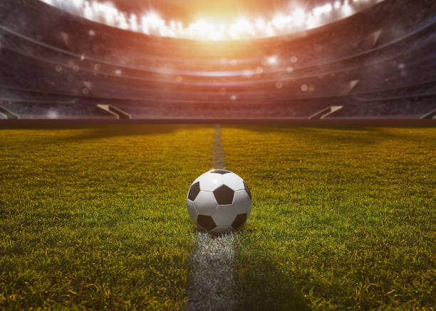 ball on the green field in soccer stadium. ready for game in the midfield stock photo