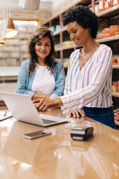 istock Female entrepreneurs using a laptop together in their ceramic store 1434694062