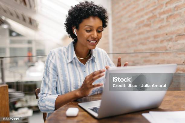 Ethnic Small Business Owner Having A Video Call In A Warehouse Stock Photo - Download Image Now