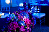 decorated in disco style table in a dark banquet hall.
