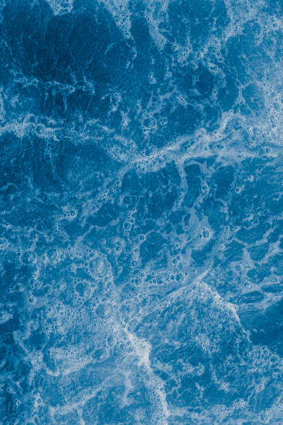 istock Dark blue sea surface with waves, splash and bubbles 1434696615