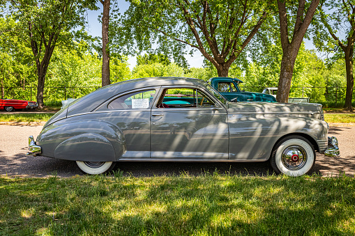 Falcon Heights, MN - June 19, 2022: High perspective side view of a 1947 Packard 2106 Custom Super Clipper Club Sedan at a local car show.
