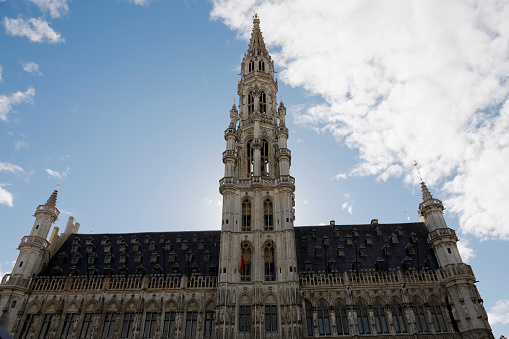 Brussels, Belgium - September 16, 2022: The upper part of the Brussels City Hall tower as seen from the Grand Place