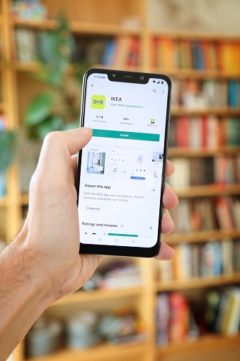 User installing Ikea furniture shopping mobile app on an Android OS, Xiaomi smart phone.