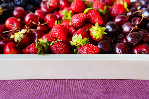 tray with strawberries, cherries and blackberries on a tray. healthy and delicious dessert. farm harvest.