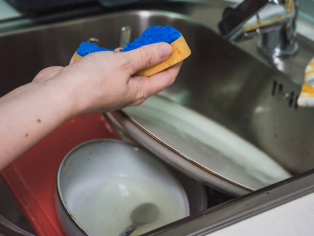 istock Unrecognizable woman's hands washing dishes in the kitchen 1434706238