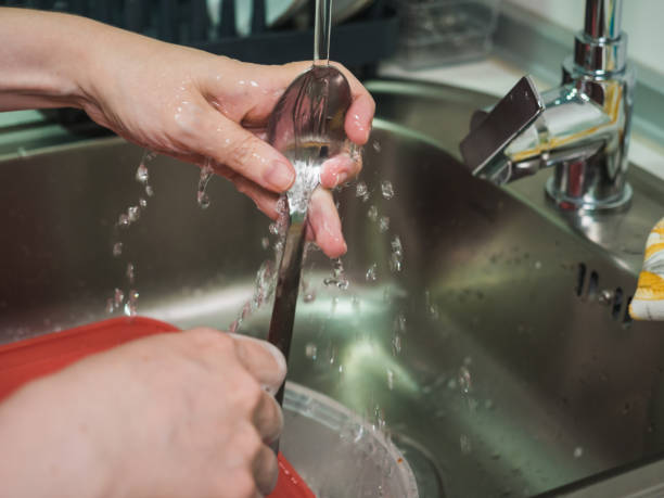 istock Unrecognizable woman's hands washing spoon in the kitchen 1434706267