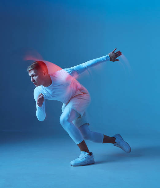 istock Sprinter start. Male strong muscular athlete starts running on blue background. 1434707214