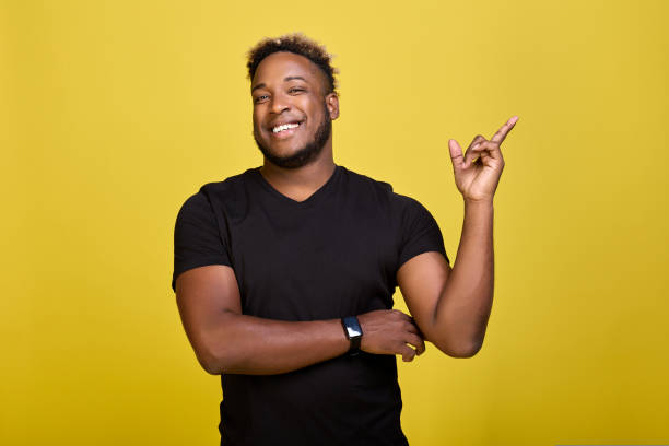 istock Cheerful black guy with a smart watch on his arm dreams of doing the same. 1434708671