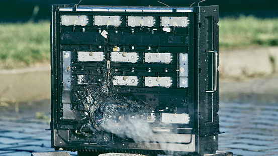 Photovoltaic battery set on fire in a controlled testing environment. Damaged parts after the fire. Green renewable energy fire safety and improvement tests