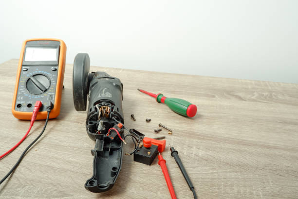 istock Power tool repair. Angle grinder disassembled for repair on the table. Screwdriver, multimeter. 1434708926
