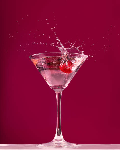 istock Raspberry splash in a martini cocktail glass on red background 1434709636