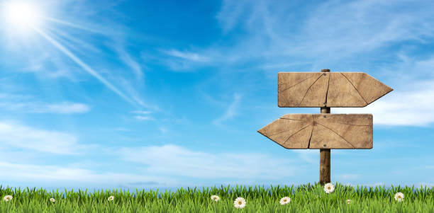 two wooden directional signs with pole on a countryside landscape - directional sign wood sign footpath imagens e fotografias de stock