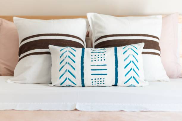 istock White bed with blue and brown stripe design pillows 1434711377
