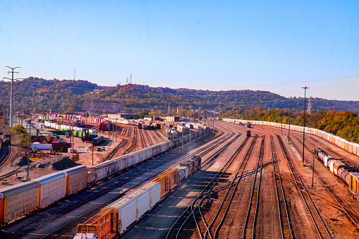 Railroad tracks in the rural country with trees.