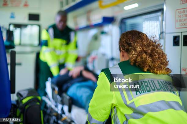 Ambulance Crew Preparing Casualty Stock Photo - Download Image Now - Ambulance, Emergency Services Occupation, Paramedic