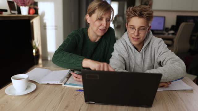 Mother helping son with some homework