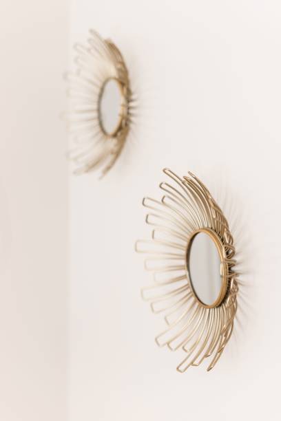 istock White wall with two beautiful round gold sun mirrors 1434722739