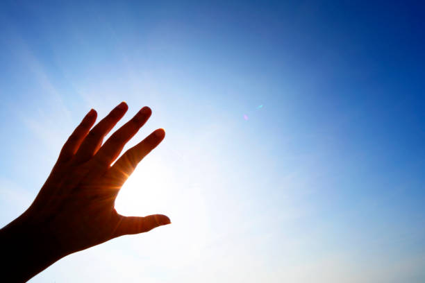 istock Hand and  sun ray with clear sky for concept idea and copy space or background 1434723678