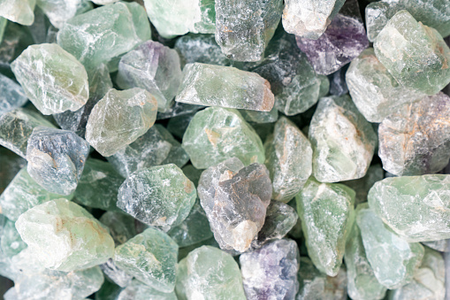 Cluster of several transparent quartz crystals close-up on a white background