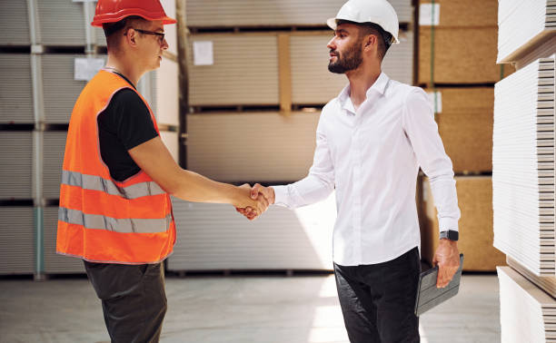 istock Standing together. Two storage workers is in the warehouse 1434725669