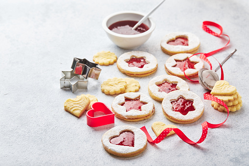 Classic Linzer Christmas Cookies with raspberry or strawberry jam on light background
