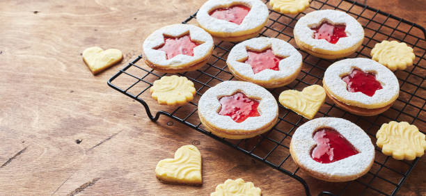 istock Classic Linzer Christmas Cookies with raspberry or strawberry jam on wooden table 1434726189