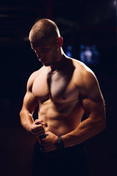 istock Strong and handsome young man with muscles and biceps in a gym 1434728892