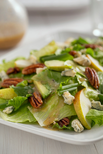 Holiday Salad - Candied pecans with blue cheese and pear on bead of romaine lettuce.