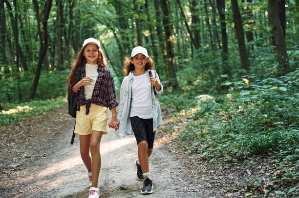 istock Walking forward. Two girls is in the forest having a leisure activity, discovering new places 1434729802