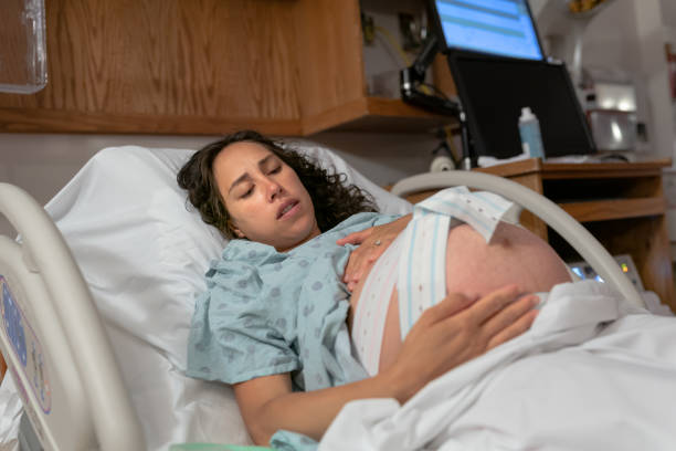 istock Pregnant Woman Having Contractions And Heartbeat Monitored In Hospital Bed 1434730004