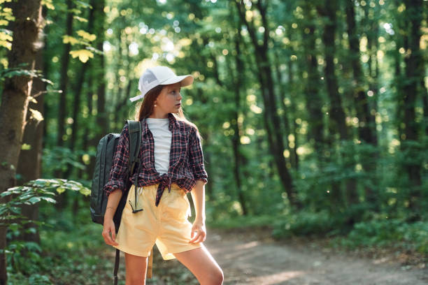 istock Standing and looking at nature. Girl is in the forest at summer day time discovering new places 1434730029