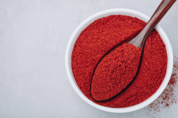 istock Chilli powder. Smoked chilli paprika. Red chilli powder paprika in bowl on gray stone background. 1434730148