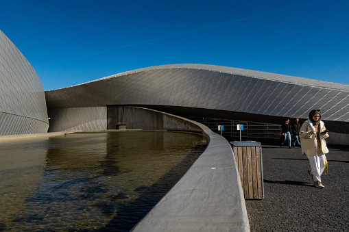 Copenhagen, Denmark Sept 23, 2022 A person walking outside the landmark Copenhagen Aquarium, or The blue Planet.
