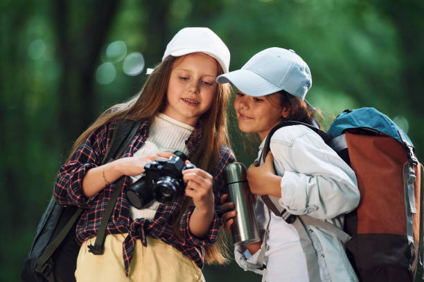 istock Front view of two girls that is in the forest having a leisure activity 1434732609