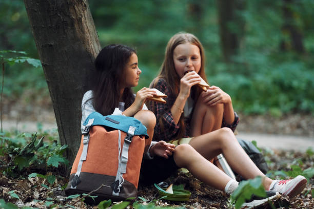 istock Two girls is in the forest having a leisure activity, discovering new places 1434732825