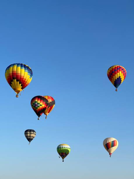 istock Vertical shot of colorful hot air balloons in a blue sky 1434732869