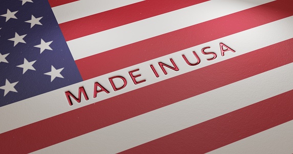 Made in USA. Embossed metallic red text on USA flag background denoting American production. 3D illustration