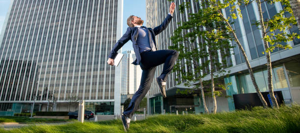 istock agile business. professional network administrator hold computer. boss with modern laptop. Man jumping, banner with copy space. 1434735757