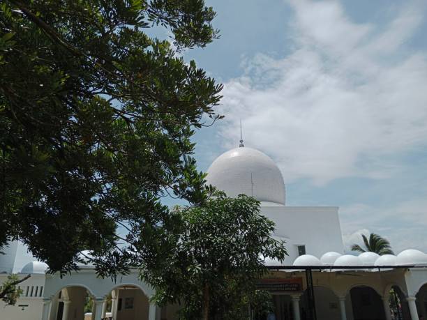 istock Cloud sky with tree branches, there is a white dome of the mosque 1434735877