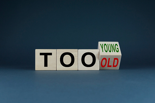 Too young or too old. Cubes form words Too young or too old. Concept of age discrimination - social problem