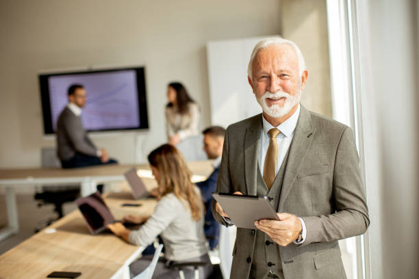 istock Senior business man workin on digital tablet in the office 1434737664