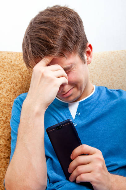 istock Sad Young Man with a Phone 1434739181