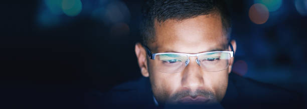 istock Thinking, research and business man working late on online project in a dark corporate office. Serious data analyst searching the internet, planning a strategy, inspired and focus on problem solving 1434740407