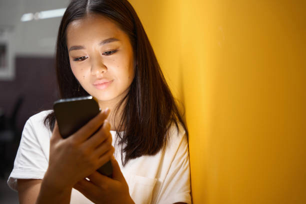 istock Asian lady holding smartphone in the office 1434740689