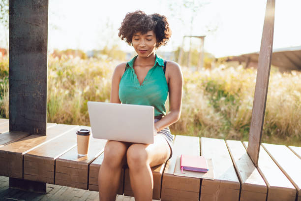 istock Prosperous dark skinned female freelancer typing on laptop computer spending sunny day in park use 4G internet, positive african american woman watching webinar learning using technology on leisure 1434742799